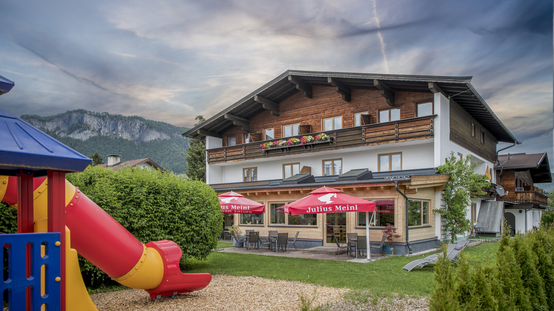 Das Familienhotel Central mit Spielplatz und Rutsche, dahinter das Kitzbüheler Horn
